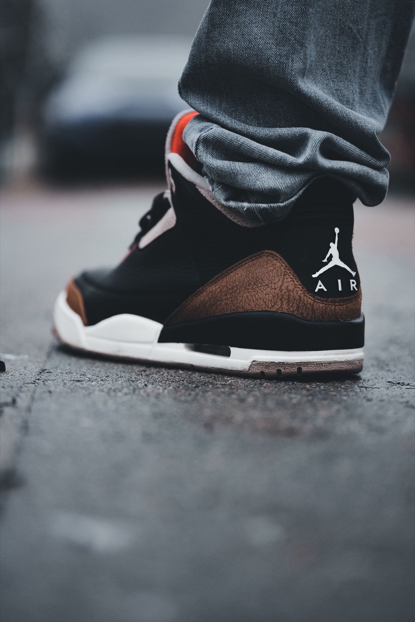 Air Jordan 3 on wet pavement